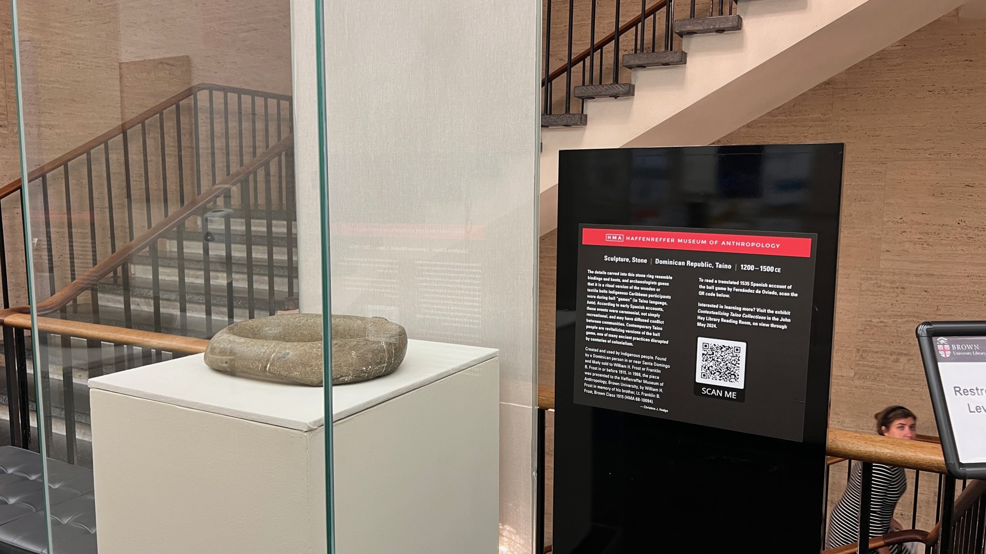 a stone ring in an exhibit case with a text panel to the right