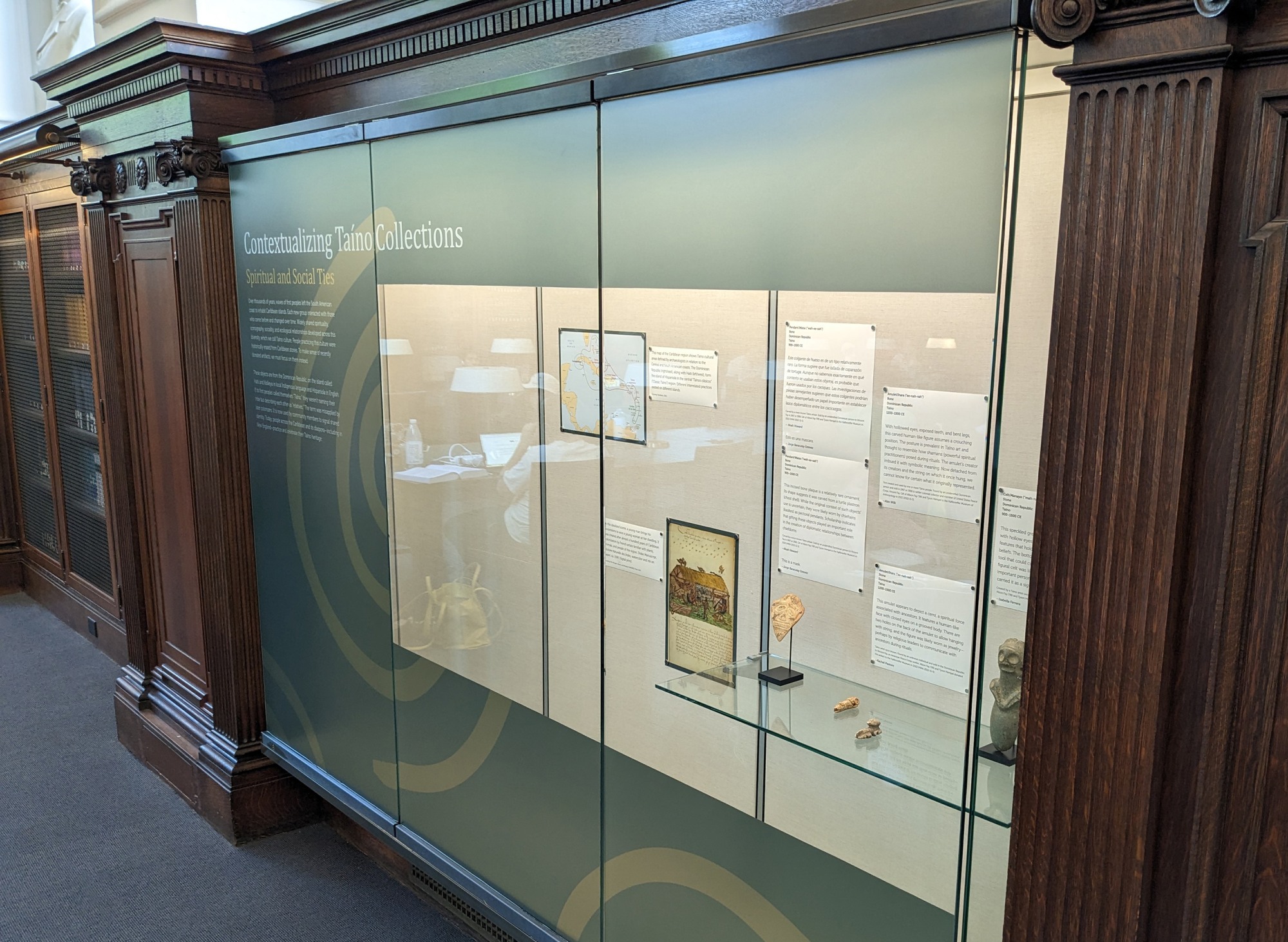 exhibit case with Caribbean artifacts and digital prints