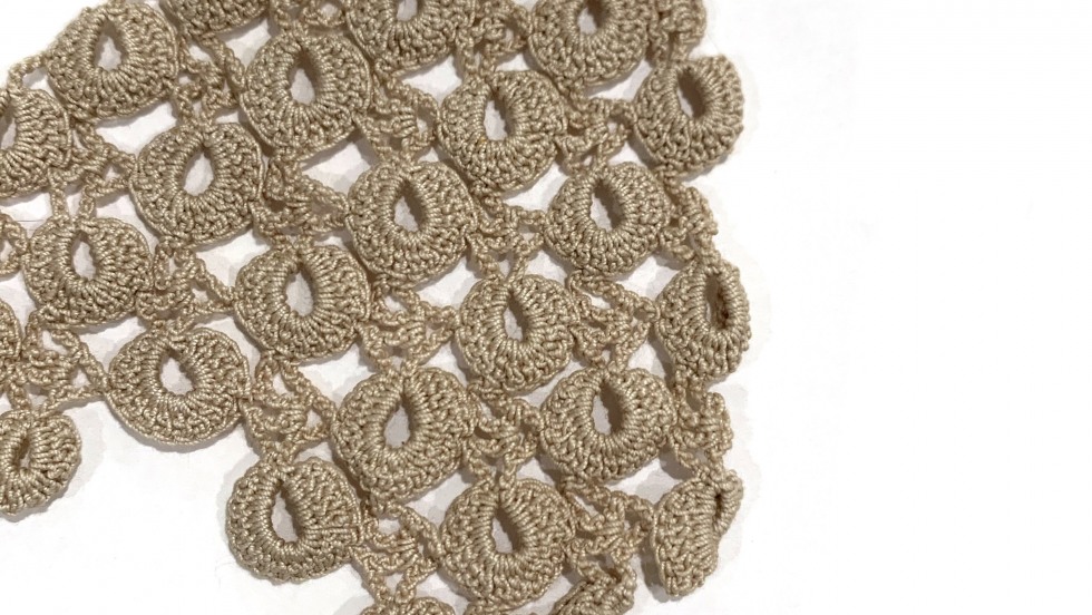 Up-close detail of scallop-type lace crochet-work. 