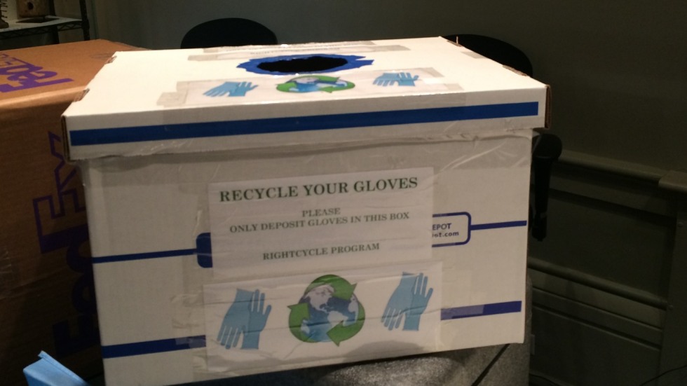 Photo of modified cardboard box for recycling nitrile gloves in the museum offices.